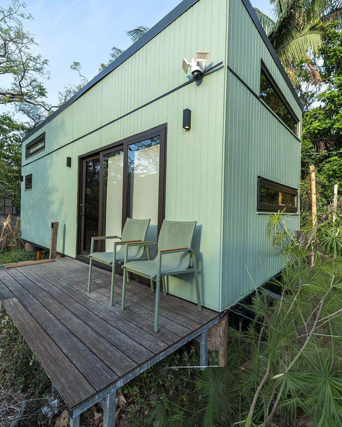 Athena eco tiny home with wooden deck surrounded by jungle in Nosara, Costa Rica