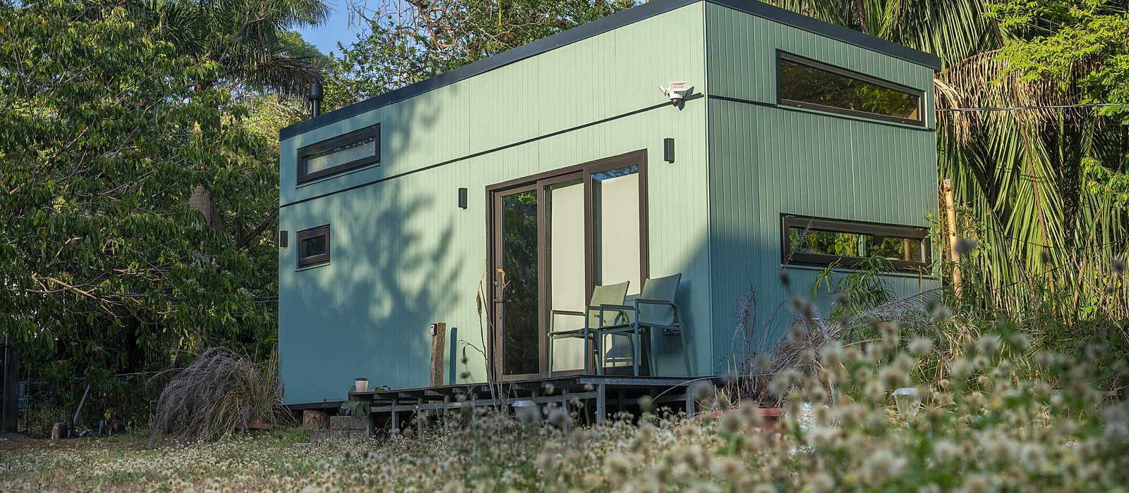 Eco tiny home in a flowering meadow at the edge of the Nosara jungle